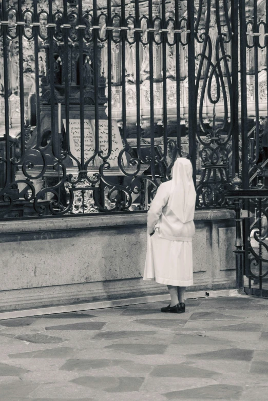 the person is standing outside next to a gate