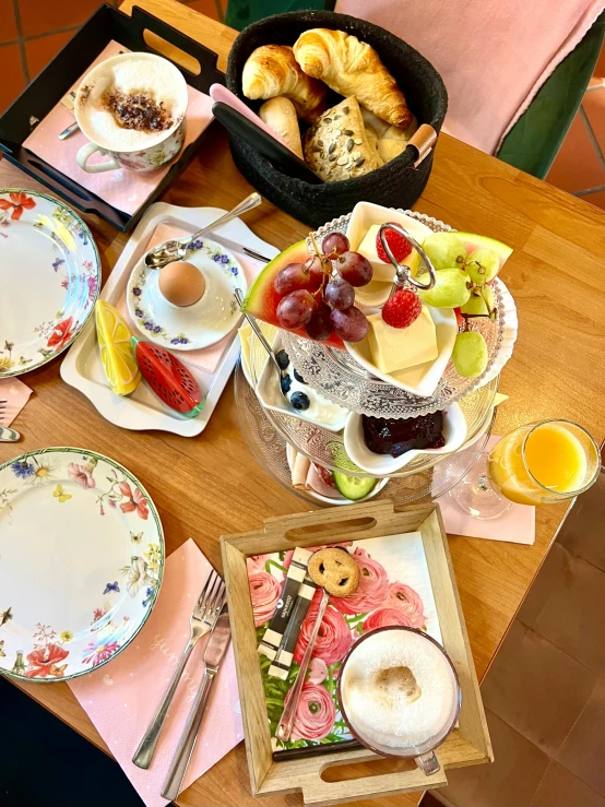 a wooden table topped with plates and dishes