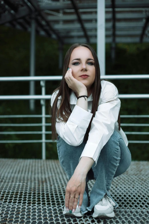 a woman poses with her hand on her knee