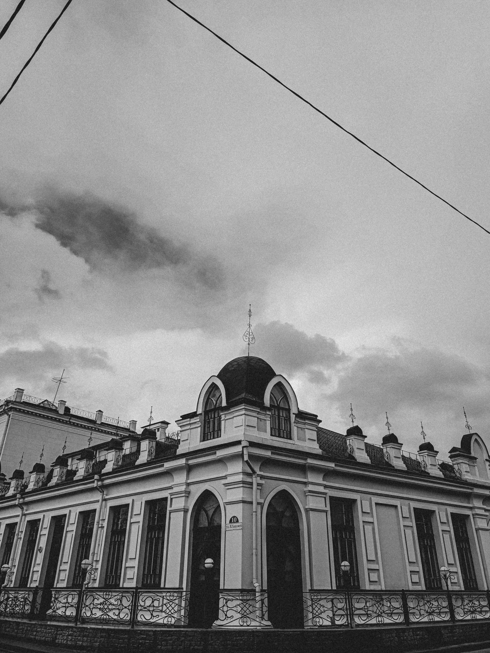 the building is white and black with a black dome on top