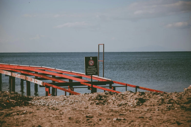 an orange bridge crosses over a large body of water