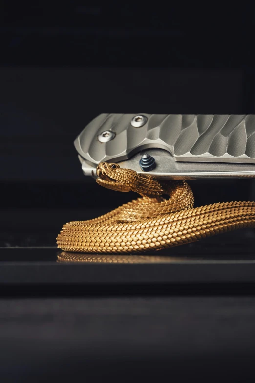 a golden rope that is tied on to a gold knife