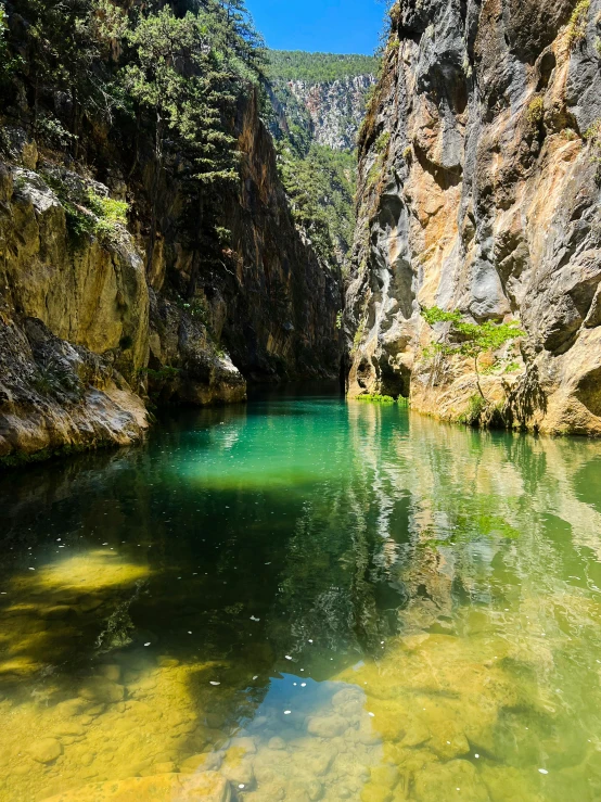 a narrow river running between a rocky outcropping