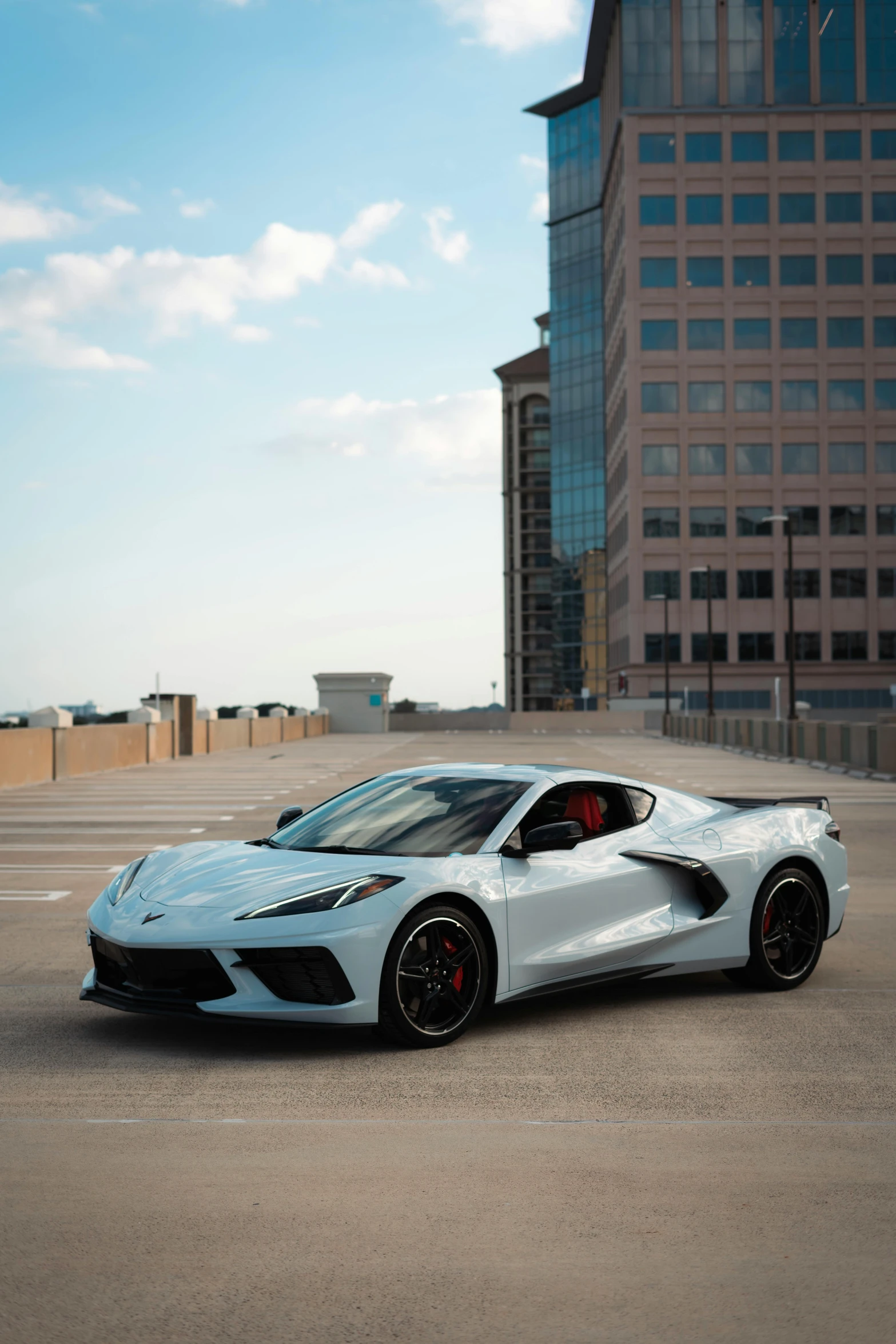 white sports car parked in the parking lot