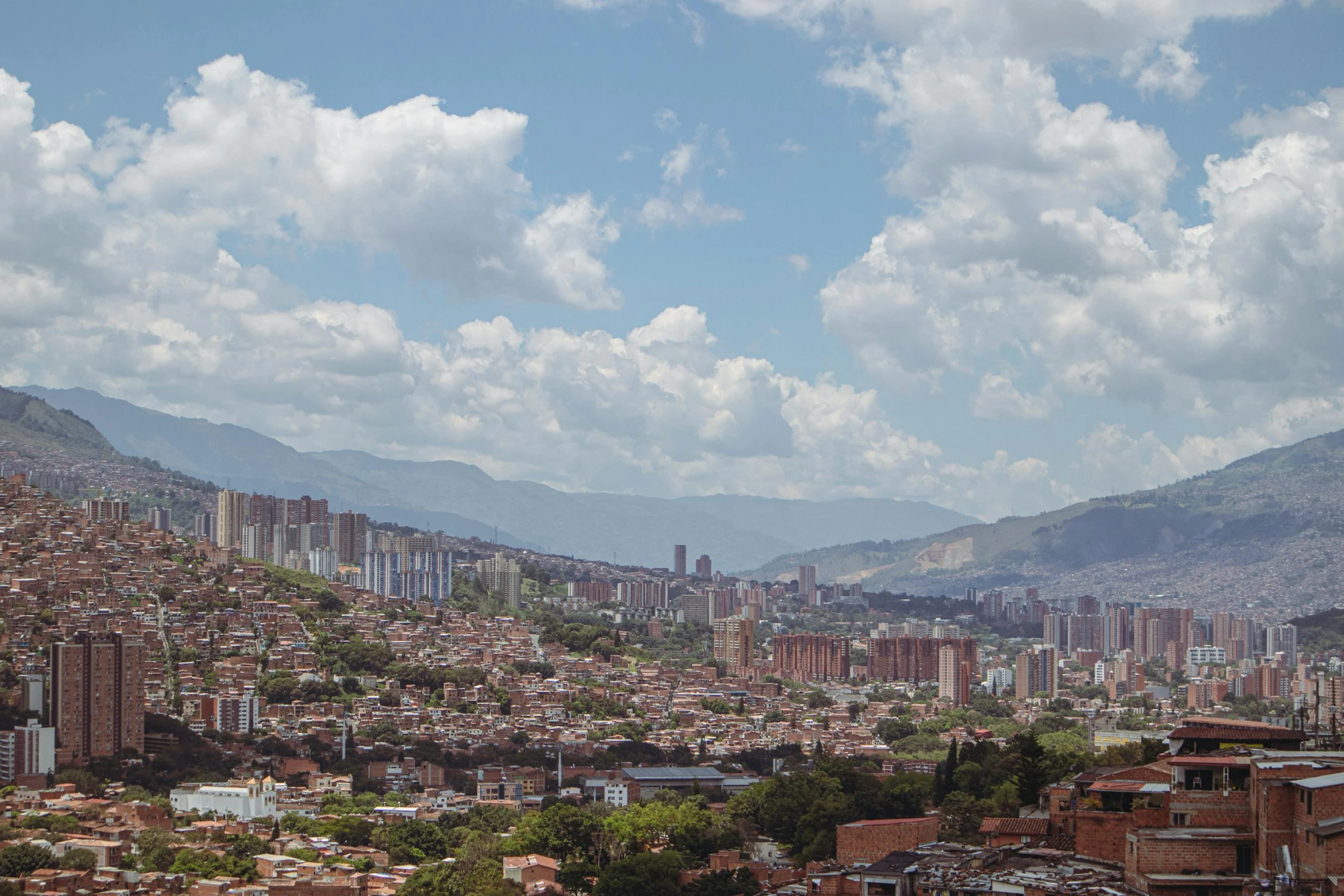 the large city has a lot of mountains in the background