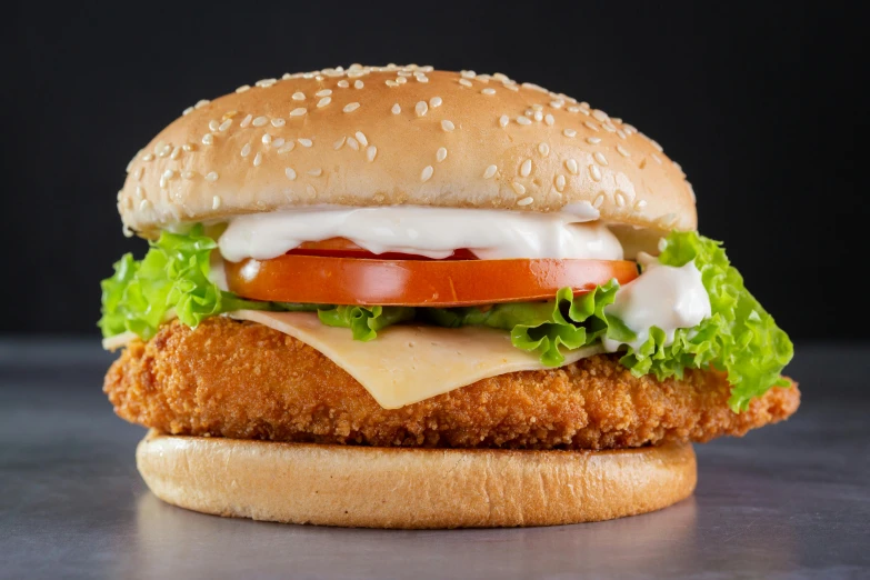 a chicken sandwich on a wooden surface