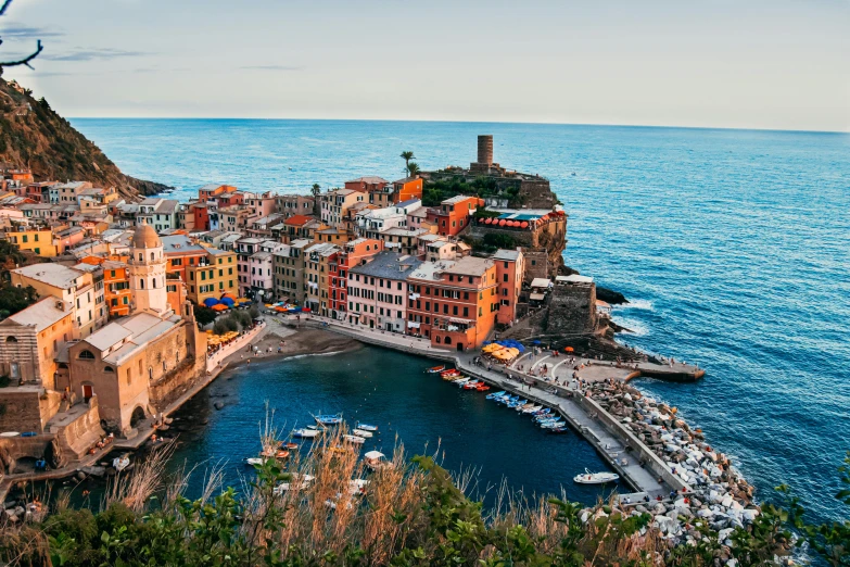 a city sitting on the side of a cliff near a body of water