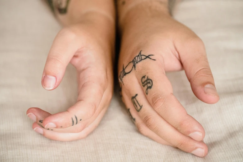 a small hand tattoo of two arrows on the palm