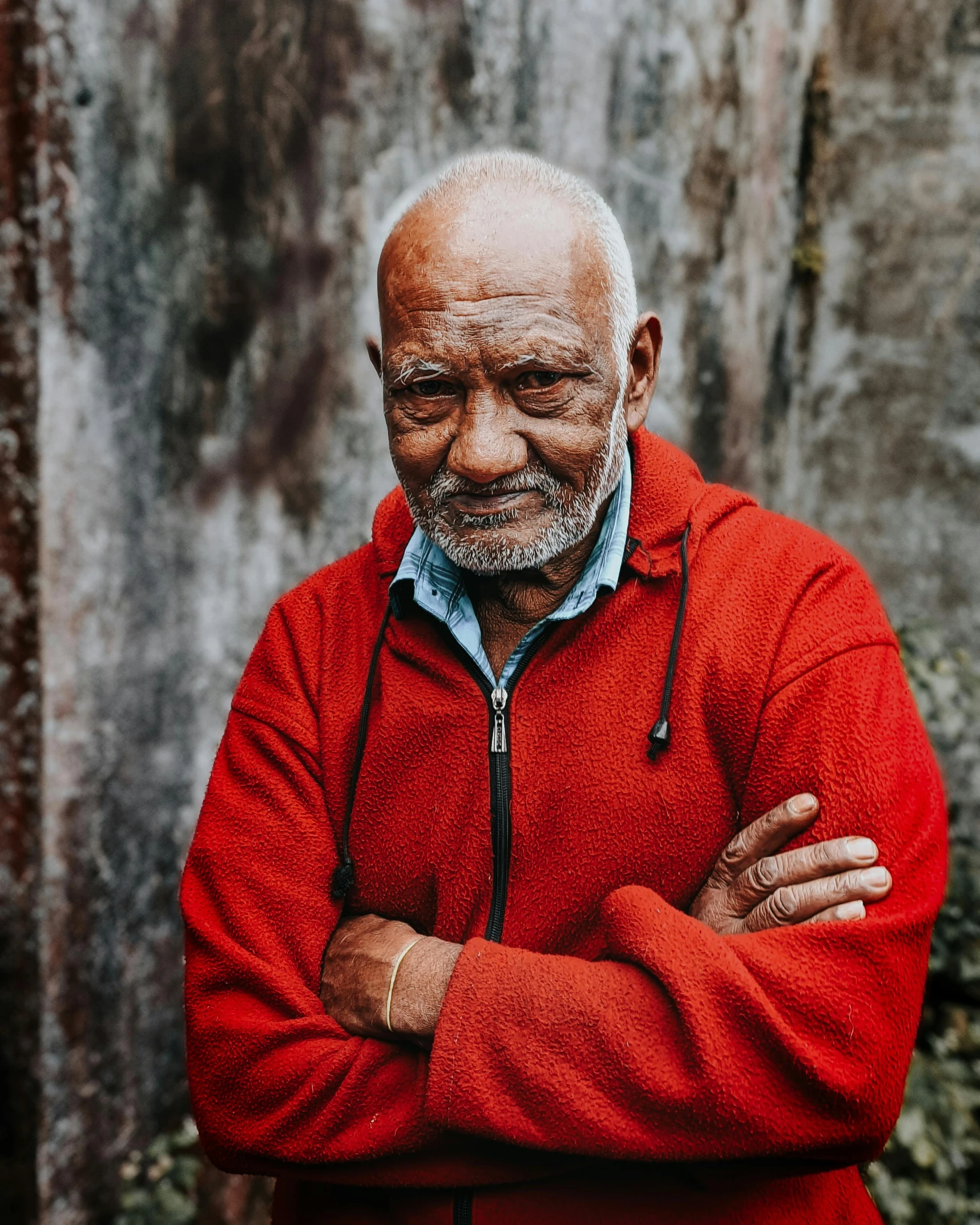 the man with a red jacket is posing for a picture