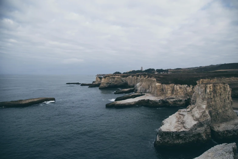 an ocean that has many small rocks on the water