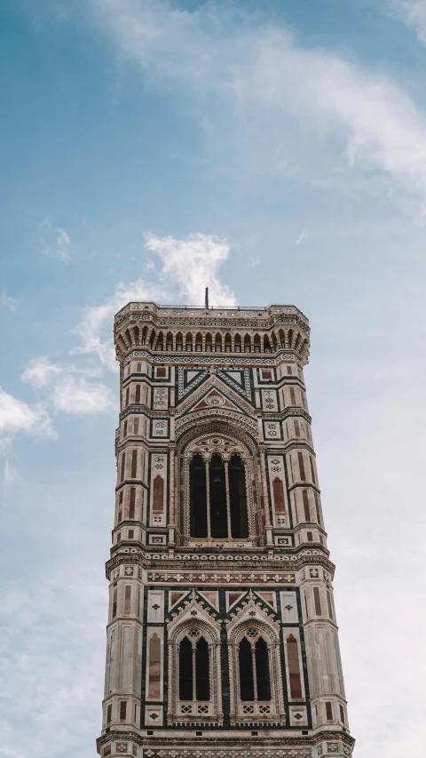 a tall tower that is sitting under a cloud filled sky