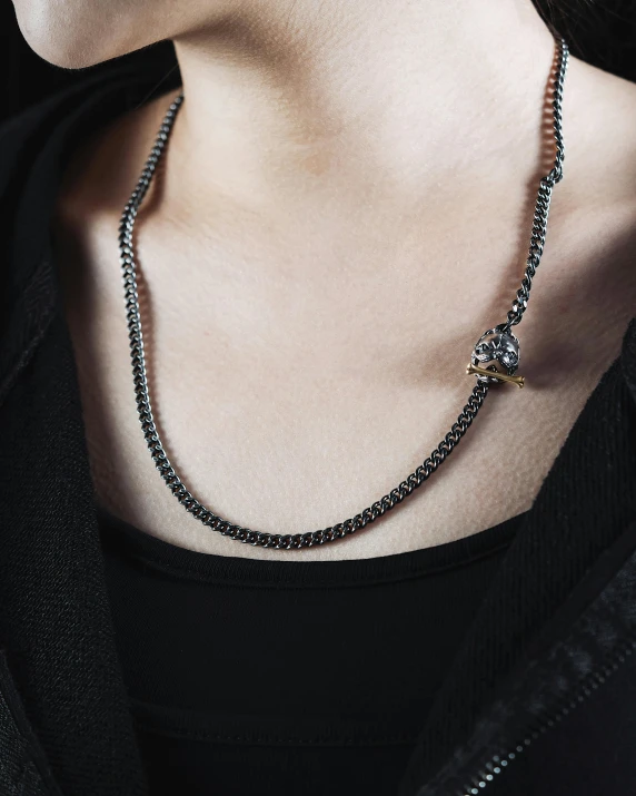 the necklace is black and silver with a bow