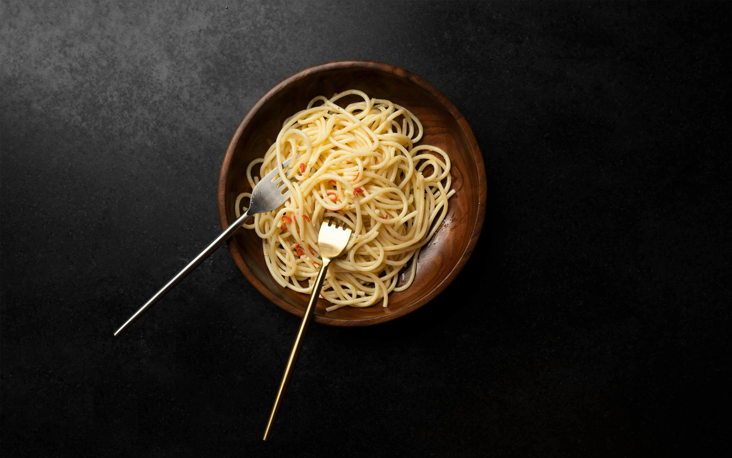 a small wooden bowl filled with food and a fork