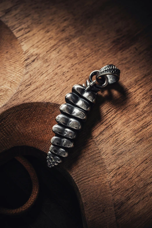 a close up of the top of a neck piece with a black bead on it