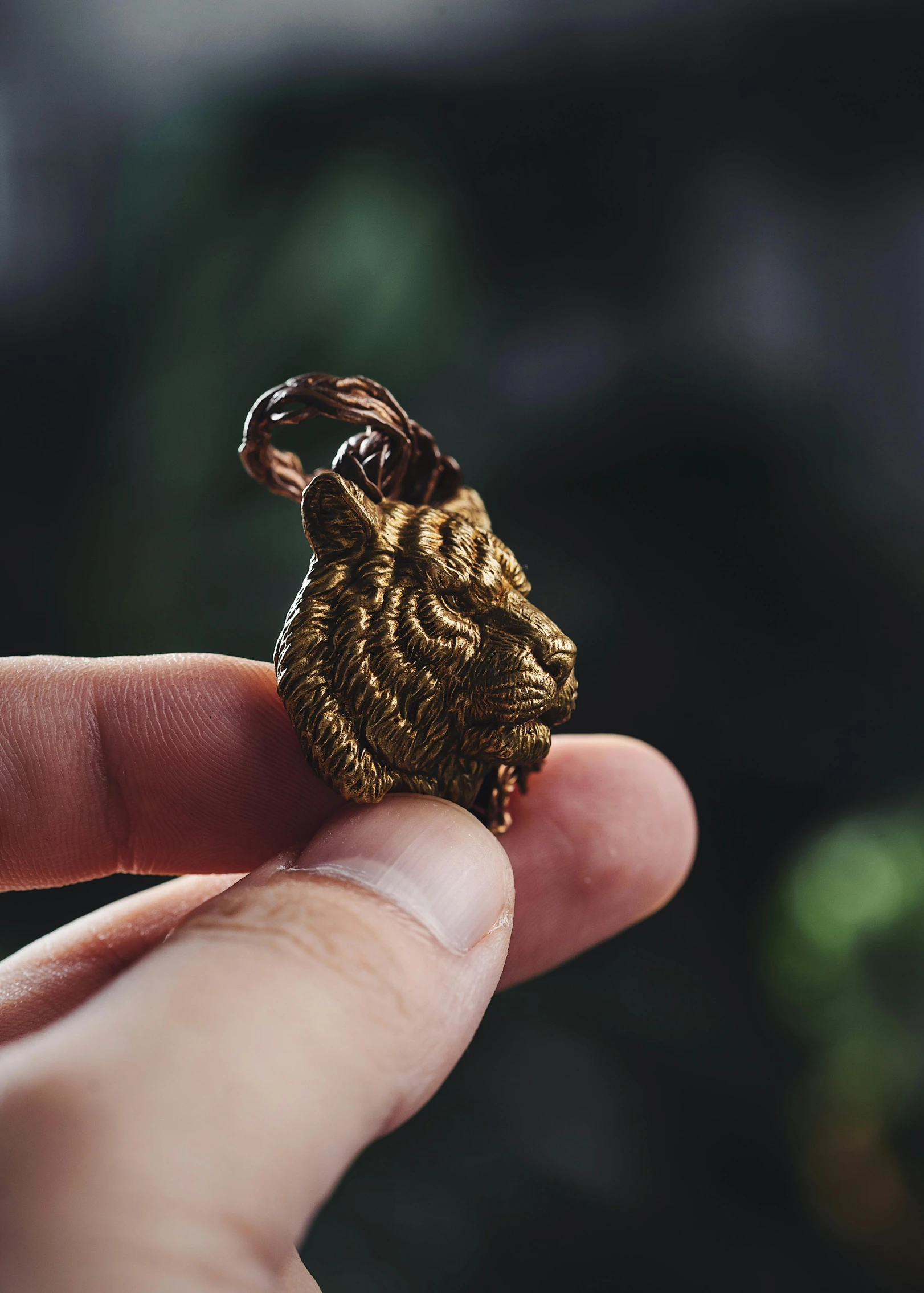 a small golden ring is held in someones hand