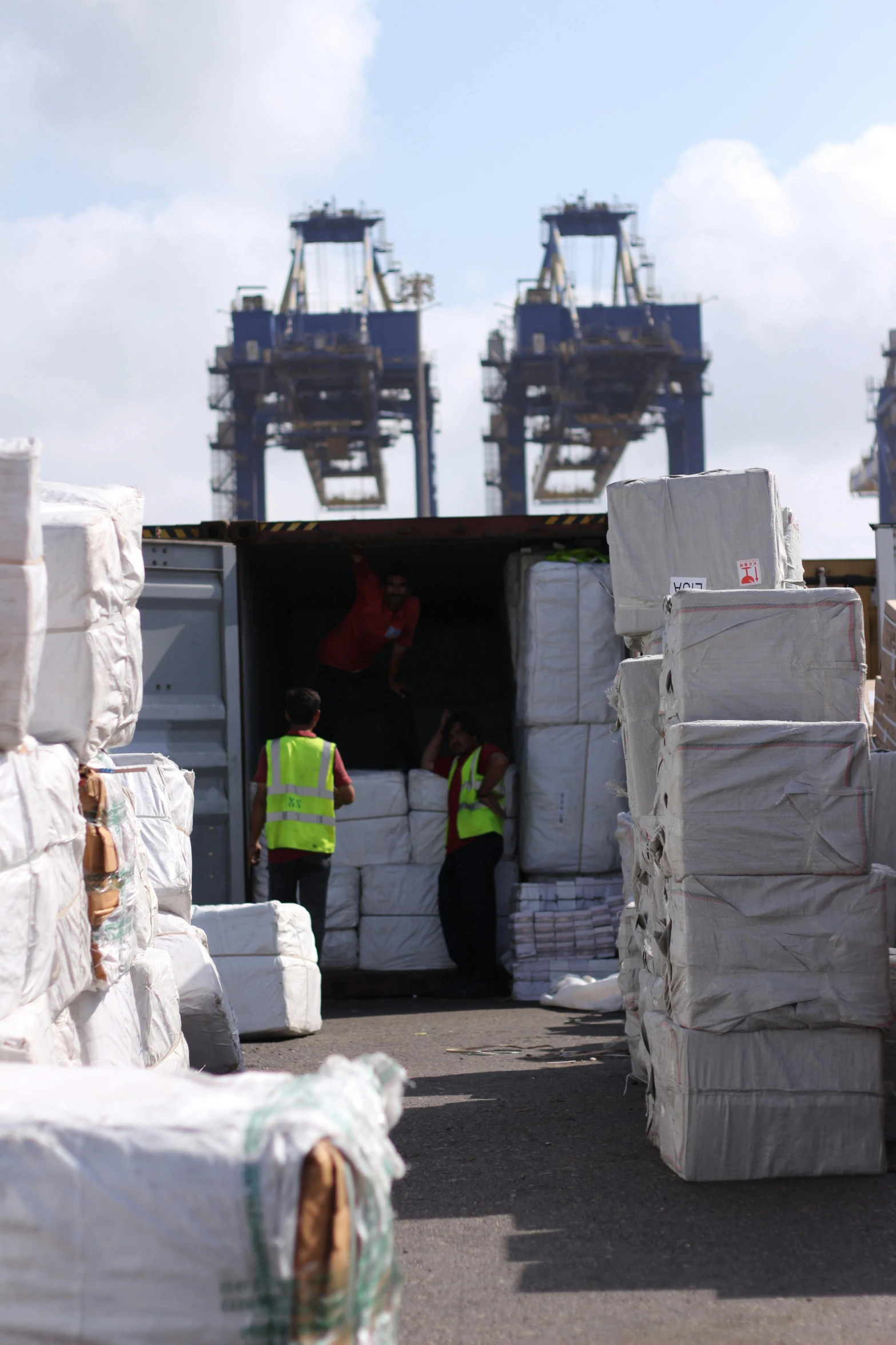 workers loading boxes into the back of a large truck