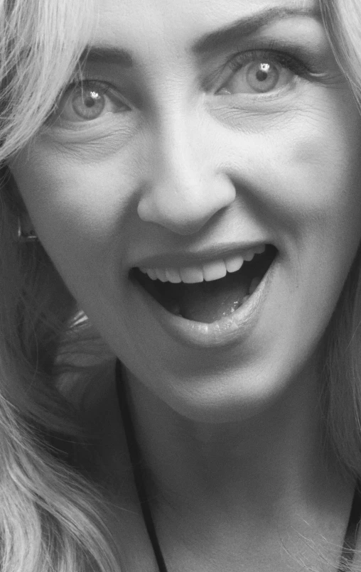 there is a black and white pograph of a woman with an excited look on her face