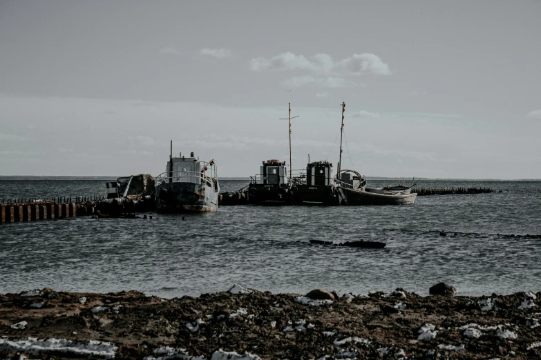 two boats sitting side by side on the beach