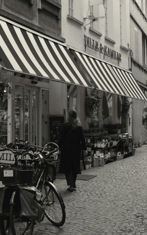 a man in a black and white po standing next to two bicycles