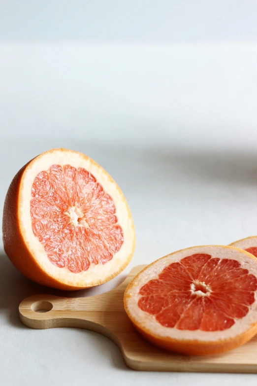 an orange sliced in half sitting on top of a  board