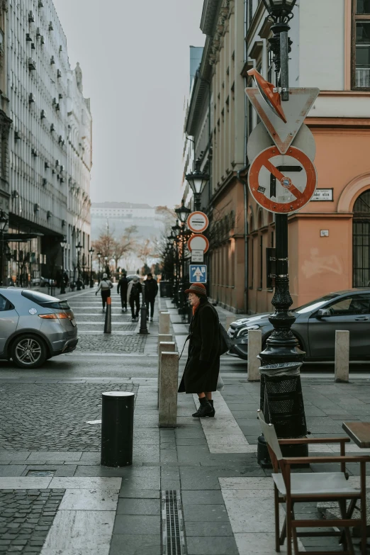 a sidewalk area with people walking and a sign on it