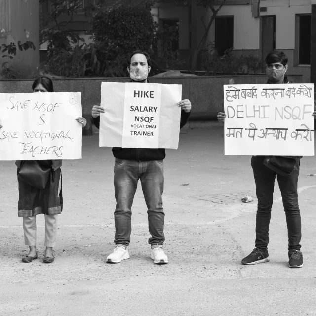 people holding signs in each of their hands