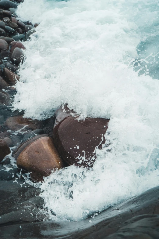 the rocks have white foam coming off them