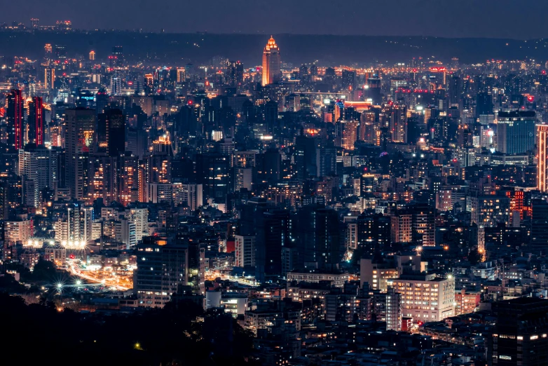 a night time view of a city with lights from tall buildings