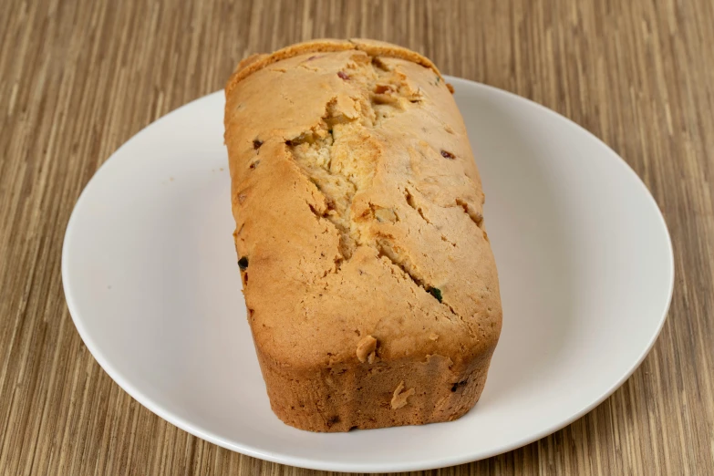 bread loaf on white plate on wood table