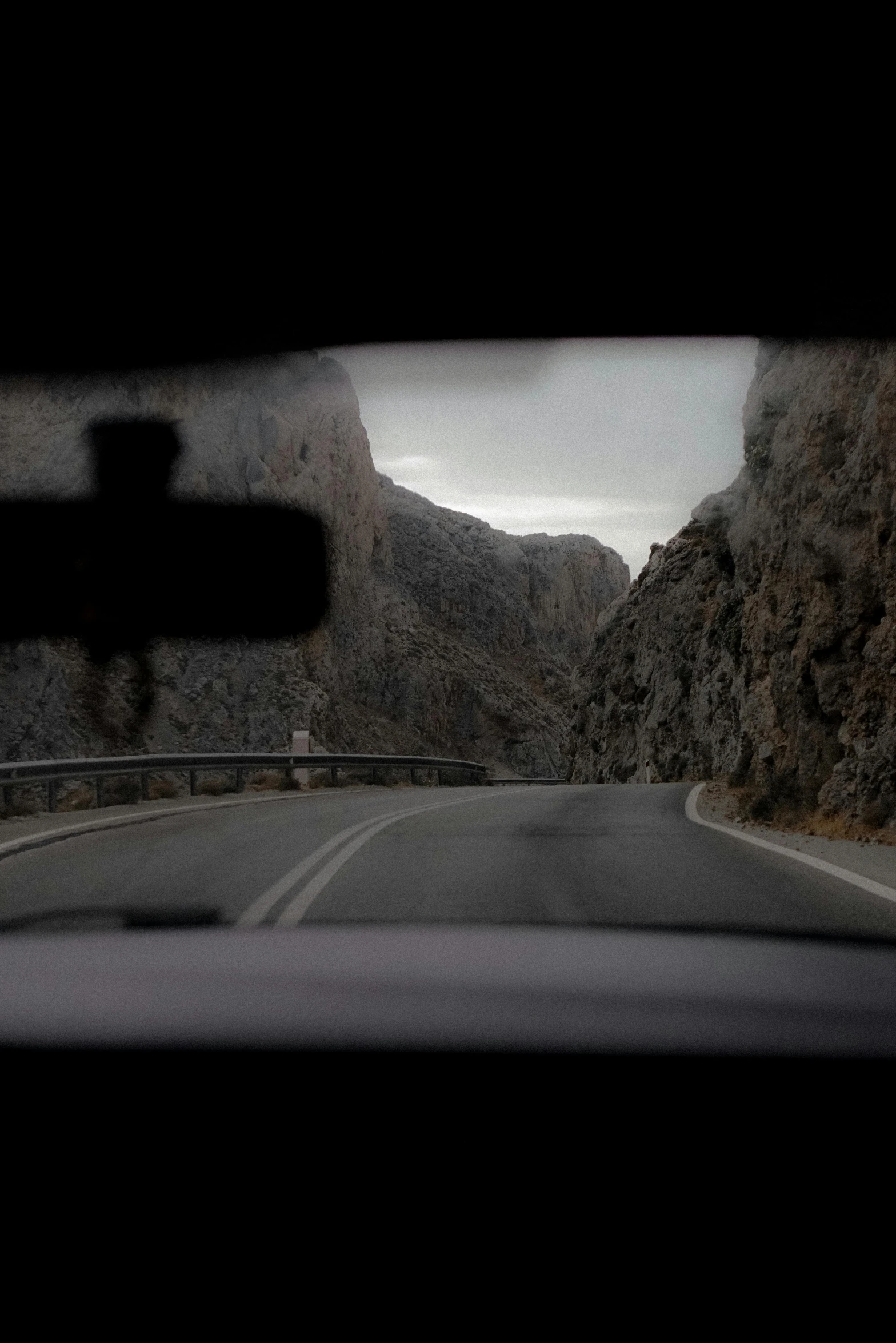 a car's windshield and the mirror reflected in it