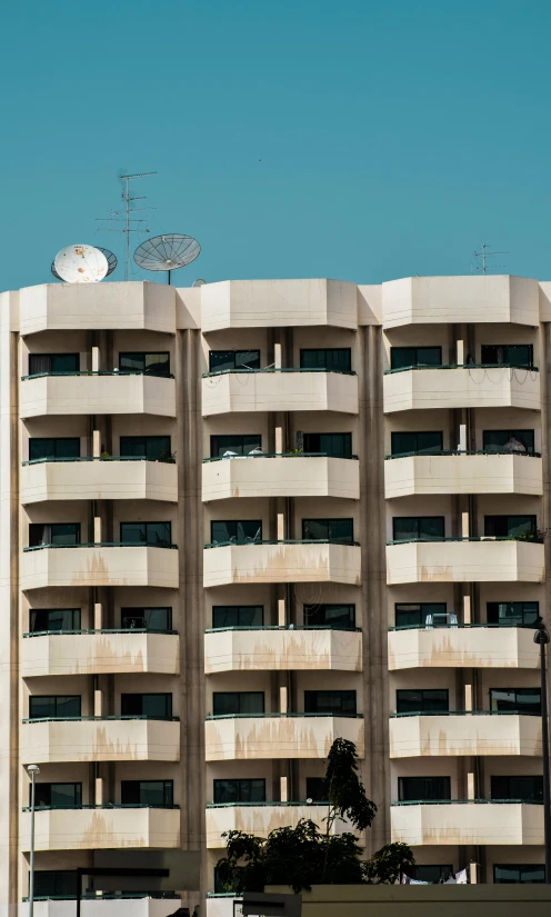 a grey concrete building with a bunch of windows