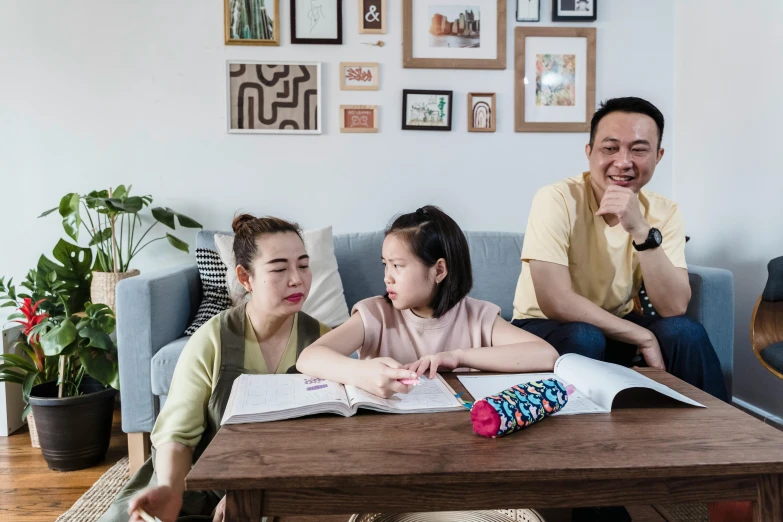 a family sitting on couchs in front of a coffee table