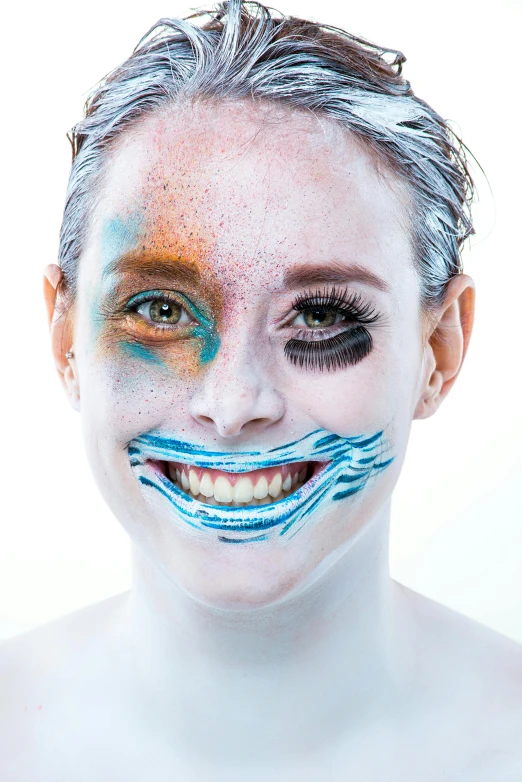 a woman with blue and silver makeup with a mustache on