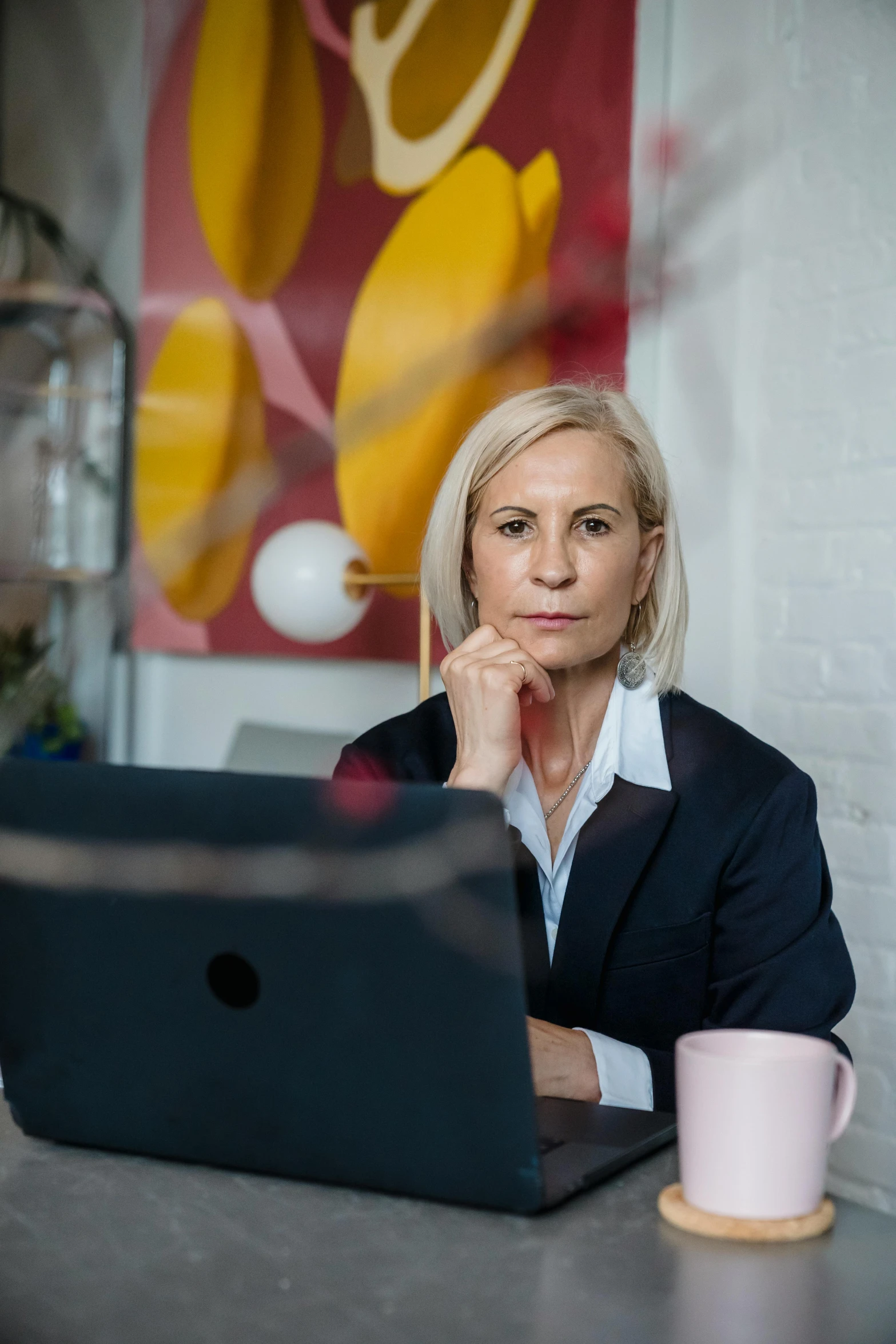 the woman is using her laptop computer at the desk