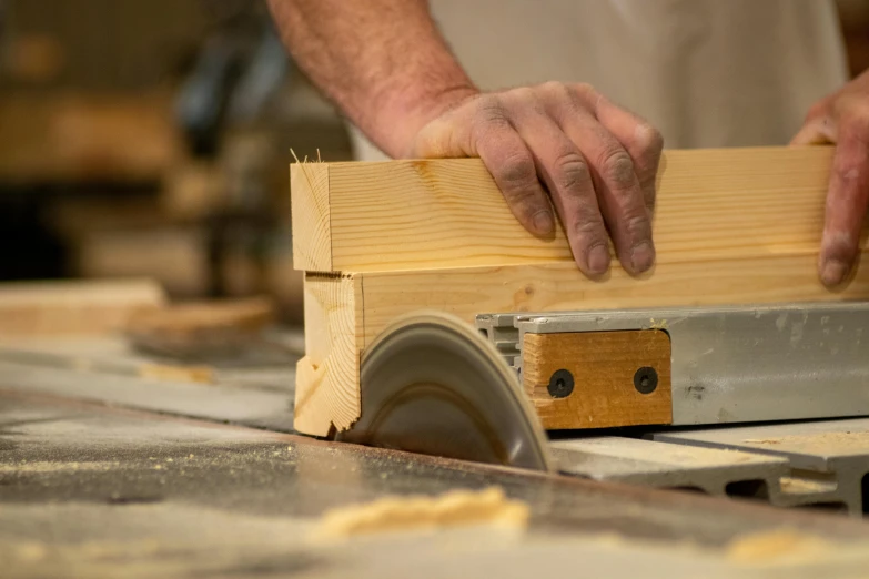 the person is working on the wooden object