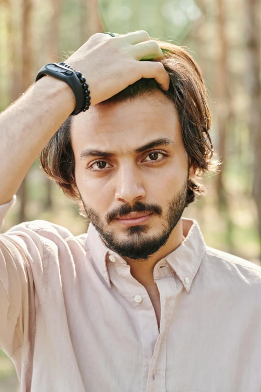 a bearded man in an unoned pink shirt