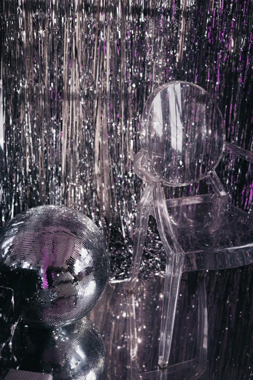 a shiny plastic object on display with silver and purple paint