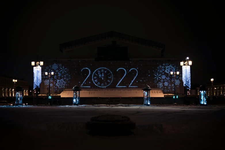 some lights and numbers on a building during the night