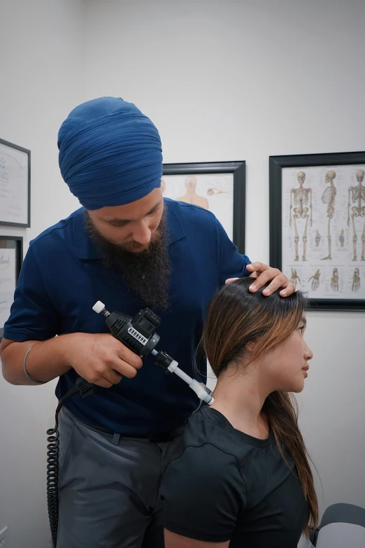 a man getting his hair styled by a female