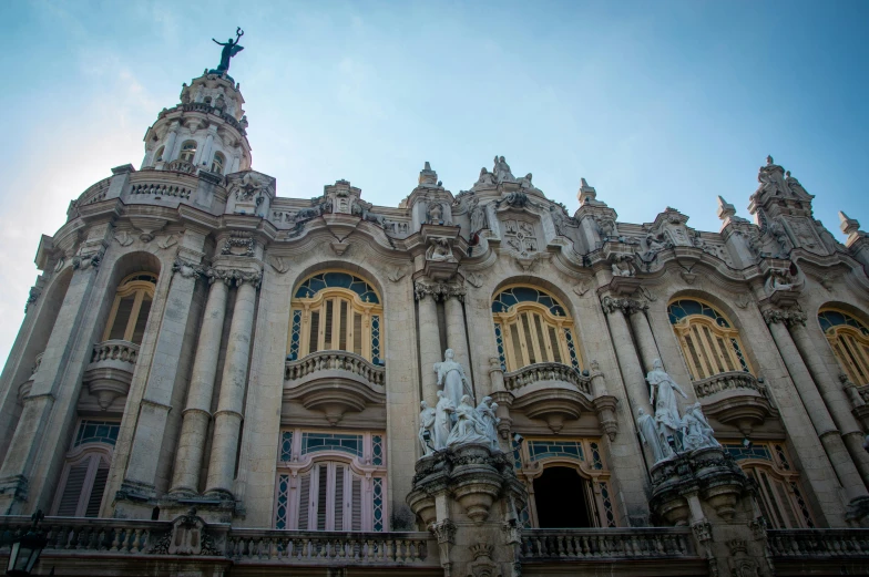 an old building with two statues and windows