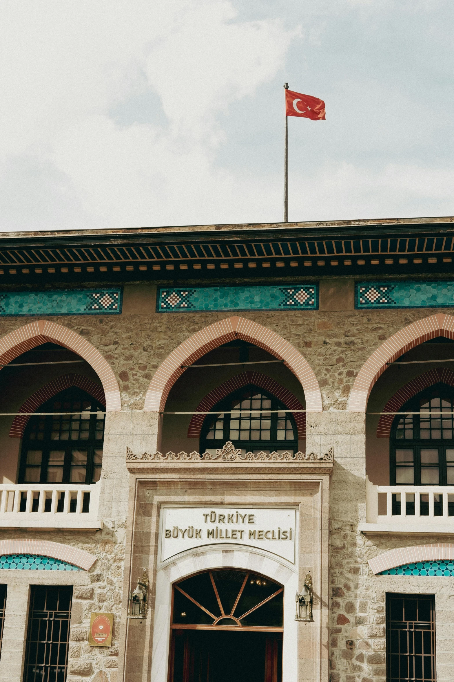 a large brick building that has a flag on the roof