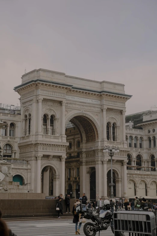 a motorcycle parked in front of a large building