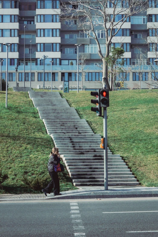 two people at a stoplight in front of a building