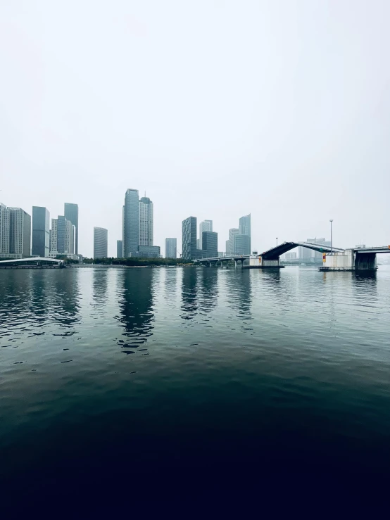 the city is in a foggy sky next to the water