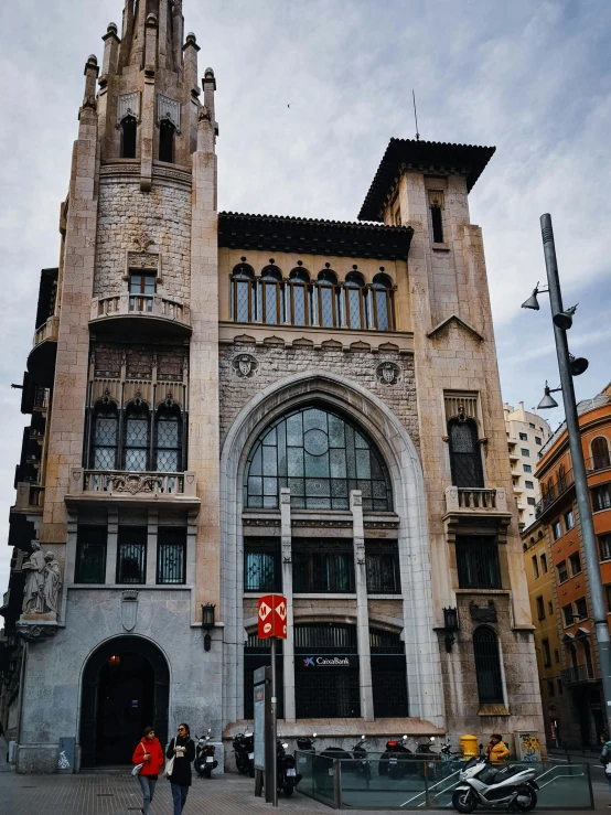 a tall stone building with a clock tower on top