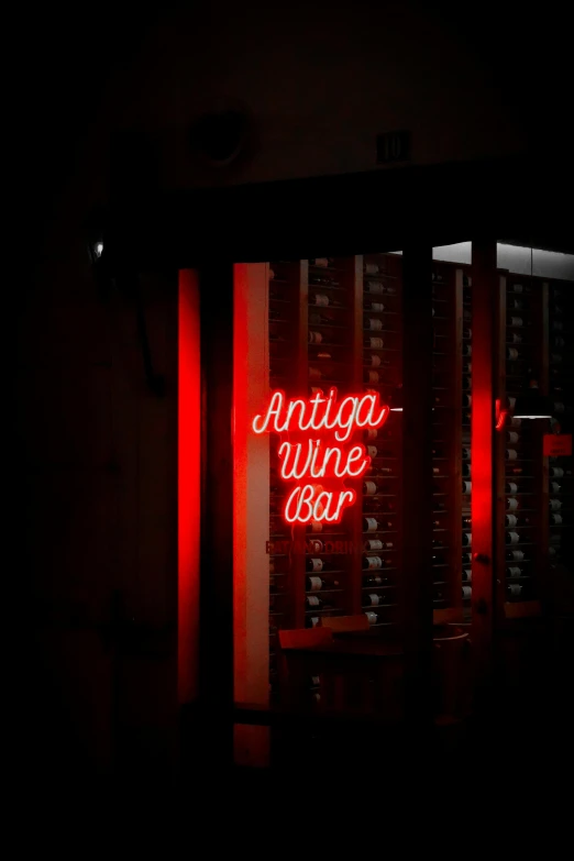 a dark room that has a red neon sign