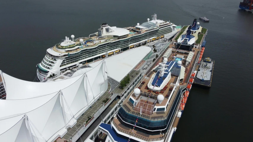 a cruise ship at dock next to a tall white building