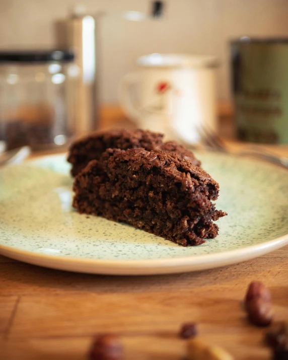 chocolate cake sitting on a plate near an open canister