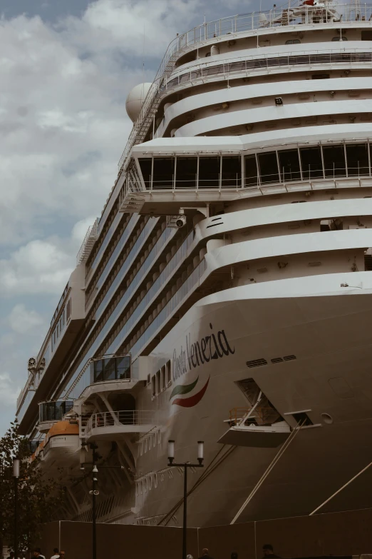 the large boat is docked on the ocean side