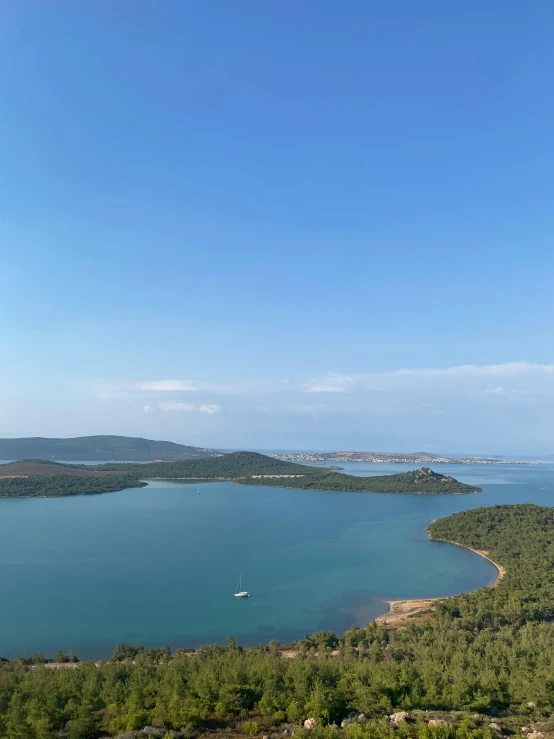 an aerial view of a large lake next to forest